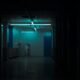 Shadowy abandoned room with a camera in the foreground, evoking a viral TikTok found-footage horror aesthetic.