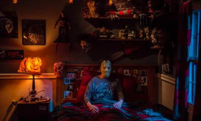 Scary Halloween night at home with pumpkins, candles and a horror movie on TV