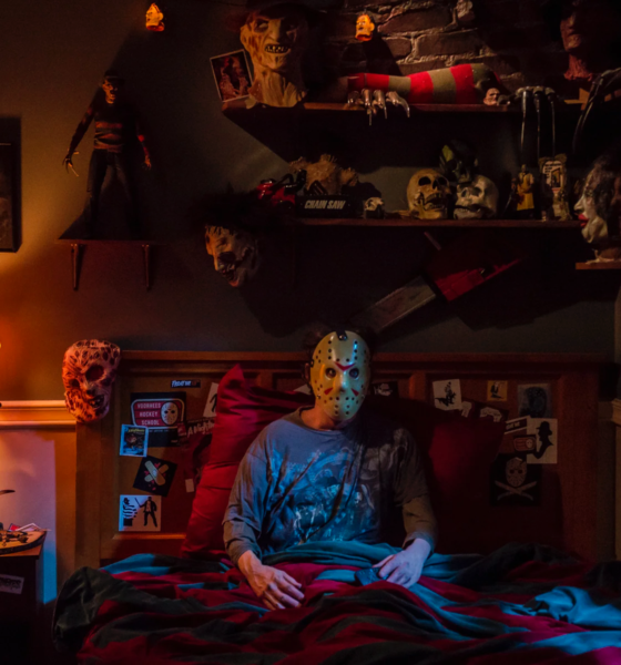 Scary Halloween night at home with pumpkins, candles and a horror movie on TV