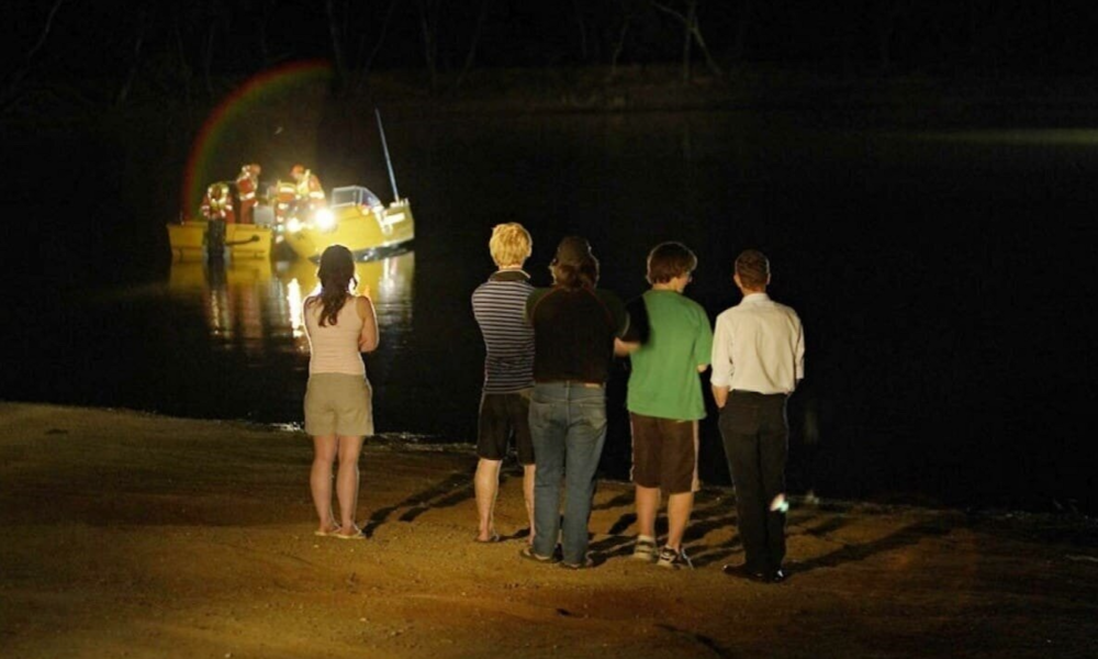 A scene from Lake Mungo showing characters staring out at the lake at night, featured in GoreCulture’s list of psychological horror movies.